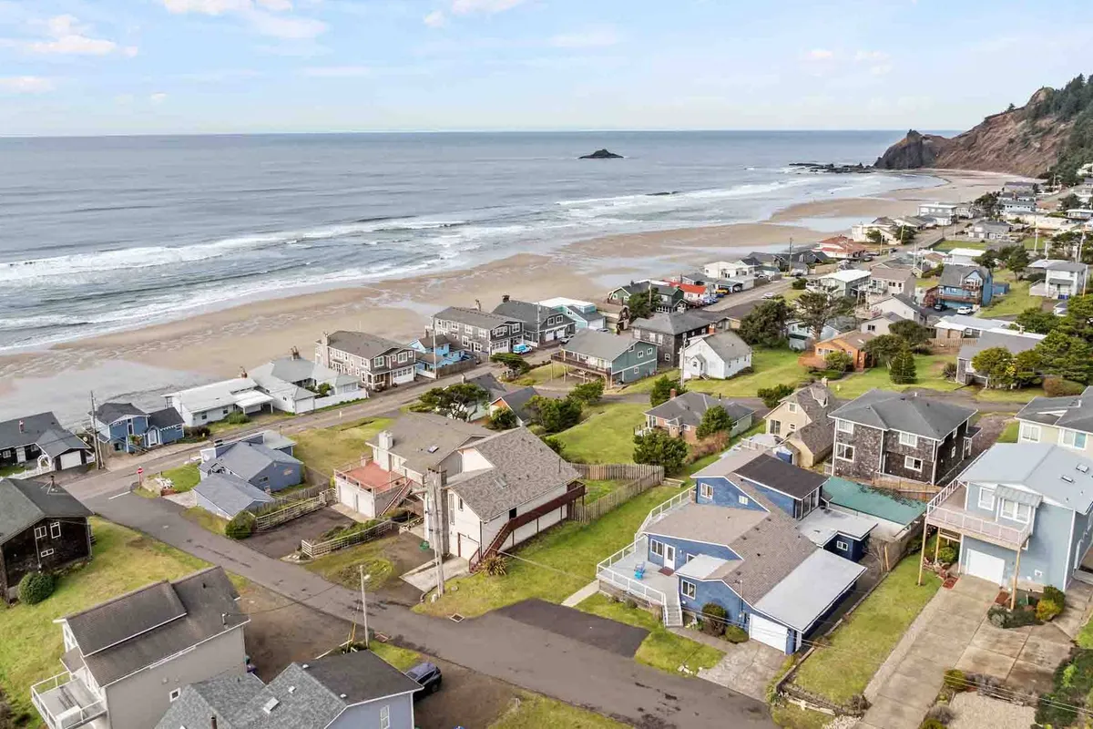 This exterior view captures the relaxed neighborhood setting of West Haven, with beachfront houses, residential streets, and a sweeping ocean view in the background. The image exudes a sense of proximity to the coast and the easygoing lifestyle, instantly signaling access to local attractions and the outdoors.
