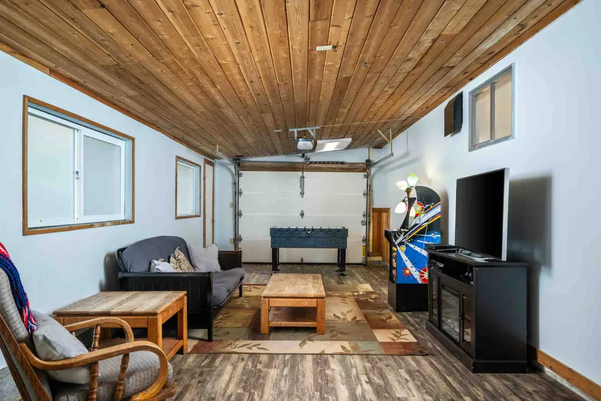 A vibrant entertainment room equipped with a foosball table, arcade machine, and comfortable seating, designed for group enjoyment and a lively atmosphere. The room invites socializing, game tournaments, and relaxation.